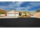 Charming single-story home featuring a three-car garage, landscaped front yard, and stucco exterior, inviting curb appeal at 6688 Martinsville Pl, Las Vegas, NV 89110