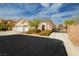 Charming single-story home featuring a two-car garage, desert landscaping, and gated entrance at 6688 Martinsville Pl, Las Vegas, NV 89110