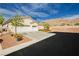 Inviting single-story home featuring a three-car garage, desert landscaping, and mountain views at 6688 Martinsville Pl, Las Vegas, NV 89110