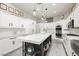 Bright kitchen features custom cabinets, an island, and stainless steel appliances at 6688 Martinsville Pl, Las Vegas, NV 89110