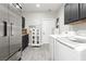 Spacious laundry room features plenty of counter space, storage, and stainless steel appliances at 6688 Martinsville Pl, Las Vegas, NV 89110