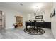 Elegant living room featuring gray tile floors, a grand piano, and stylish decor, creating a welcoming atmosphere at 6688 Martinsville Pl, Las Vegas, NV 89110