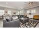 Bright living room featuring a comfortable gray sectional, plantation shutters, and elegant decor, creating a cozy ambiance at 6688 Martinsville Pl, Las Vegas, NV 89110