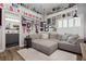 Comfortable living room featuring a plush gray sectional sofa and neutral decor at 6688 Martinsville Pl, Las Vegas, NV 89110