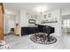 Elegant living room featuring gray tile floors, a grand piano, and stylish decor, creating a welcoming atmosphere at 6688 Martinsville Pl, Las Vegas, NV 89110