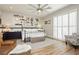Spacious main bedroom with a ceiling fan, wood-look flooring, and shuttered windows for natural light at 6688 Martinsville Pl, Las Vegas, NV 89110