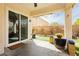 Covered patio with sliding glass doors leading to the backyard and outdoor seating area for relaxation and entertaining at 6688 Martinsville Pl, Las Vegas, NV 89110