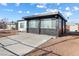 Single story home with a mix of white and black brick exterior and easy to maintain gravel landscaping at 704 Slayton Dr, Las Vegas, NV 89107