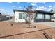 Single story home with a mix of white and black brick exterior and easy to maintain gravel landscaping at 704 Slayton Dr, Las Vegas, NV 89107