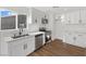 Bright white kitchen featuring modern appliances and countertops, with wood-look flooring at 704 Slayton Dr, Las Vegas, NV 89107