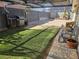 Fenced back yard with a grill, seating, and mixed gravel and artificial turf landscaping at 709 Evergreen Cir, Las Vegas, NV 89107