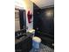 Gothic bathroom featuring black tile and decor accents at 709 Evergreen Cir, Las Vegas, NV 89107