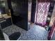 Gothic bathroom displaying black tile shower and patterned floor at 709 Evergreen Cir, Las Vegas, NV 89107