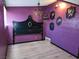 Gothic bedroom featuring purple walls with a black ornate headboard at 709 Evergreen Cir, Las Vegas, NV 89107