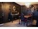 View of the dining room featuring hardwood floors, black walls, a chandelier, and a wood dining table at 709 Evergreen Cir, Las Vegas, NV 89107