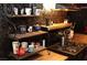 Kitchen features wood countertops, black appliances, ornate shelves with decorative coffee mugs, and tiled backsplash at 709 Evergreen Cir, Las Vegas, NV 89107