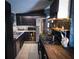 Features of this kitchen include stainless steel appliances, black cabinets, tile floors, and tiled backsplash at 709 Evergreen Cir, Las Vegas, NV 89107