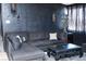 Gothic living room featuring a dark sectional sofa and black walls with candelabra-style sconces at 709 Evergreen Cir, Las Vegas, NV 89107