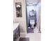 Modern bathroom featuring a toilet with shelf, grey tile floor, and neutral accents at 7607 Boca Raton Dr, Las Vegas, NV 89113