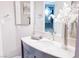 Elegant bathroom showcasing a vanity, light countertop, and floral decor at 7607 Boca Raton Dr, Las Vegas, NV 89113