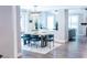 Bright dining room with modern light fixture, stylish chairs, and view into living area at 7607 Boca Raton Dr, Las Vegas, NV 89113