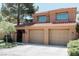 Spacious three-car garage attached to a two-story house with well-manicured lawn at 7607 Boca Raton Dr, Las Vegas, NV 89113