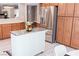 Bright kitchen features stainless steel appliances, an island with countertop, and wood cabinets at 7607 Boca Raton Dr, Las Vegas, NV 89113