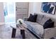 Comfortable living room showcasing a cozy grey sofa, modern art, and a stylish marble coffee table at 7607 Boca Raton Dr, Las Vegas, NV 89113