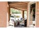 Inviting covered patio seating area with comfortable furniture and natural light filtering through the latticed pergola at 7607 Boca Raton Dr, Las Vegas, NV 89113