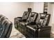 Comfortable seating in this spacious theater room with plush black leather reclining chairs and integrated amenities at 7607 Boca Raton Dr, Las Vegas, NV 89113