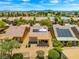 Scenic aerial view showcases community homes equipped with solar panels, lush landscaping, and nearby golf course at 7669 Fieldfare Dr, North Las Vegas, NV 89084