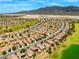 Panoramic aerial view of a well-maintained community showcasing uniform homes and green spaces at 7669 Fieldfare Dr, North Las Vegas, NV 89084