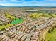 Wide aerial view of the community showcasing green spaces, mountains, and tile roof homes at 7669 Fieldfare Dr, North Las Vegas, NV 89084