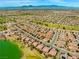 Wide aerial view of the community featuring lush landscaping, mountains, and tile roof homes at 7669 Fieldfare Dr, North Las Vegas, NV 89084