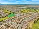 Wide aerial view of the community showcasing green spaces, mountains, and tile roof homes at 7669 Fieldfare Dr, North Las Vegas, NV 89084