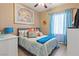 Relaxing bedroom featuring a comfortable bed, beach-themed decor, and natural light at 7669 Fieldfare Dr, North Las Vegas, NV 89084