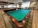 Elegant billiard room with multiple pool tables and ample seating at 7669 Fieldfare Dr, North Las Vegas, NV 89084