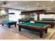 Well-lit billiard room with multiple tables provides an elegant space for recreation and leisure at 7669 Fieldfare Dr, North Las Vegas, NV 89084