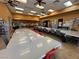 Spacious craft room with tables and equipment, perfect for creative projects at 7669 Fieldfare Dr, North Las Vegas, NV 89084