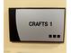 Close-up of a 'Crafts 1' sign, indicating community crafts facilities with accessibility via Braille at 7669 Fieldfare Dr, North Las Vegas, NV 89084