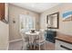 Charming dining room with a round table, four chairs, and plenty of natural light at 7669 Fieldfare Dr, North Las Vegas, NV 89084