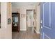 Inviting entryway featuring wood-look floors, neutral walls, and a vibrant blue front door at 7669 Fieldfare Dr, North Las Vegas, NV 89084