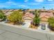 Charming single-story home with desert landscaping, mature trees, and a two-car garage at 7669 Fieldfare Dr, North Las Vegas, NV 89084