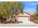 Beautiful single-story home featuring mature landscaping, a two-car garage, and desert plants at 7669 Fieldfare Dr, North Las Vegas, NV 89084