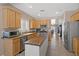 Spacious kitchen with stainless steel appliances, a wooden island, and abundant storage at 7669 Fieldfare Dr, North Las Vegas, NV 89084