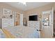 Main bedroom with a bed, a television, and a door to the living room at 7669 Fieldfare Dr, North Las Vegas, NV 89084