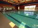 Bright and inviting indoor swimming pool with lane markers and large windows at 7669 Fieldfare Dr, North Las Vegas, NV 89084