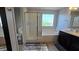 Bright bathroom features a glass-enclosed shower, soaking tub, and single sink vanity at 7704 Classy Cashmere Ct, Las Vegas, NV 89149