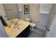 Well-lit half bath featuring a vanity with a sink, toilet, and tasteful decor at 7704 Classy Cashmere Ct, Las Vegas, NV 89149