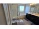 Bright bathroom featuring a glass-enclosed shower, bathtub, and dual vanity sinks at 7704 Classy Cashmere Ct, Las Vegas, NV 89149